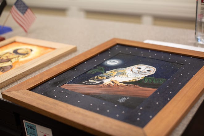 Rashawn Thompson demonstrates the art that has done by one of his customers in the Commons at Livingston, Jeffrey's Studio's Studio.